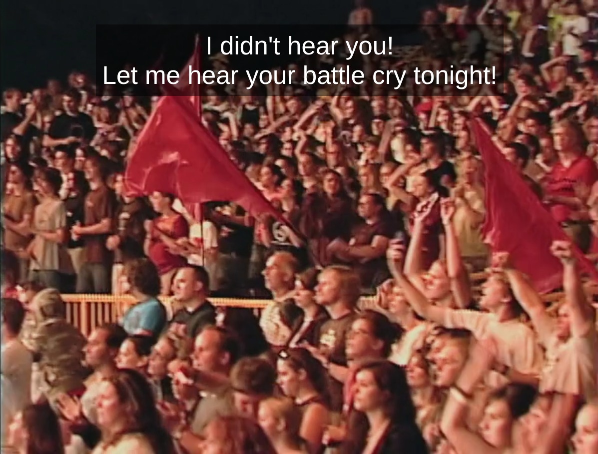 A crowd at BattleCry with a few of the flag runners. I don't know how often they were out, but there was a crew of interns that would run around the bleachers with these huge red flags. The caption is of Ron, "I didn't hear you! Let me hear your battle cry tonight!"