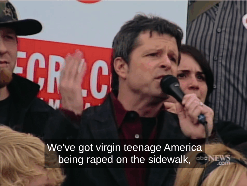 Ron at the San Fransicso protest, I think. He's on a microphone talking about how we have virgin teenagers getting raped on the sidewalk while Americans just walk by and look at it.